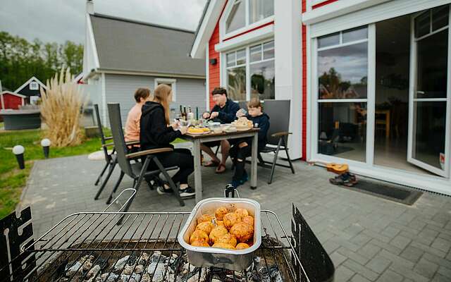 Familie am Tisch hinter dem Grill im Hafendorf Zerpenschleuse